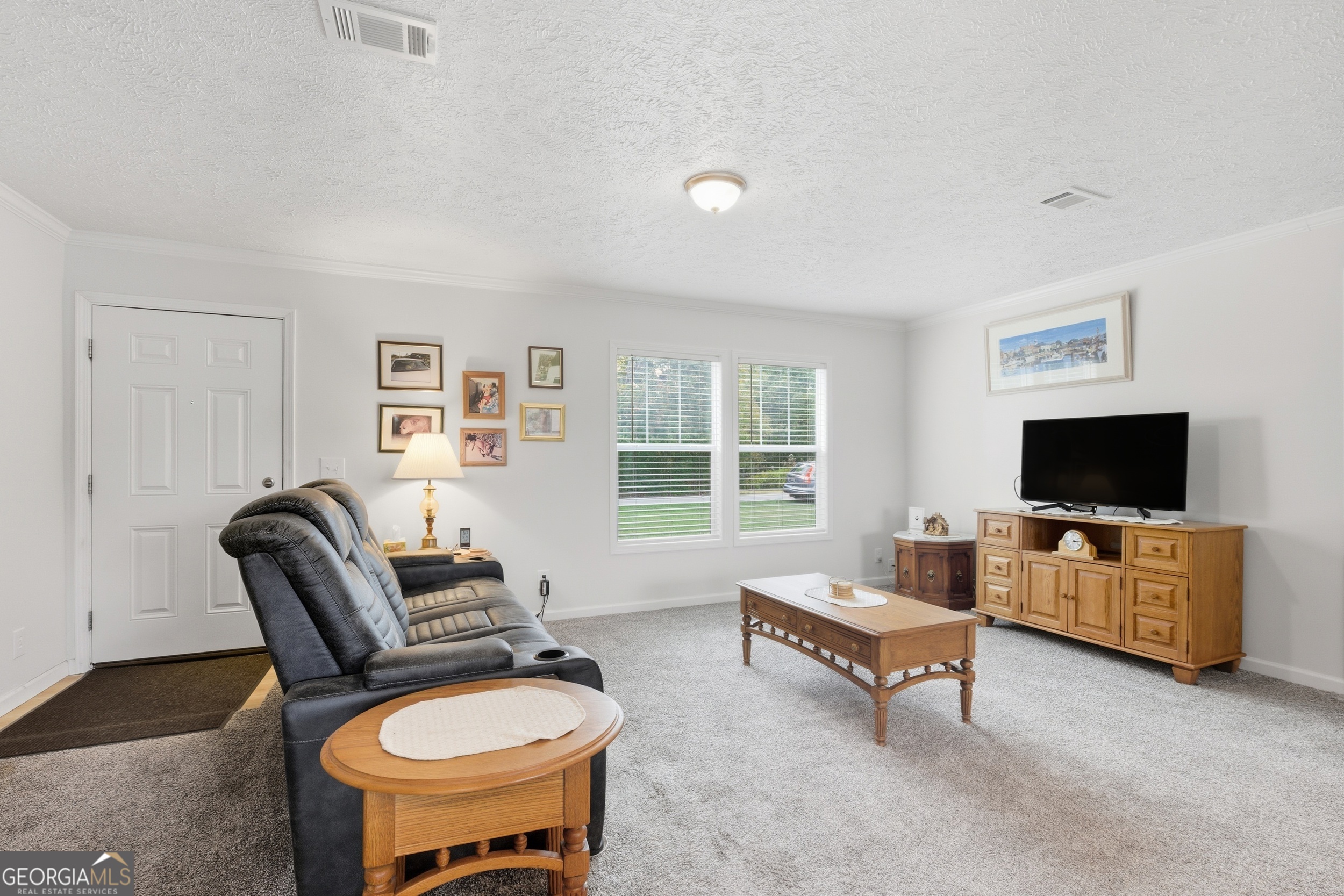 219 Eastanollee Road Eastanollee, GA 30538 - Photo 8 of 49 a living room with furniture and a flat screen tv