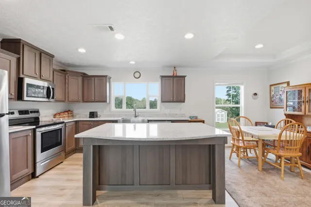 a large kitchen with lots of counter space a sink and appliances