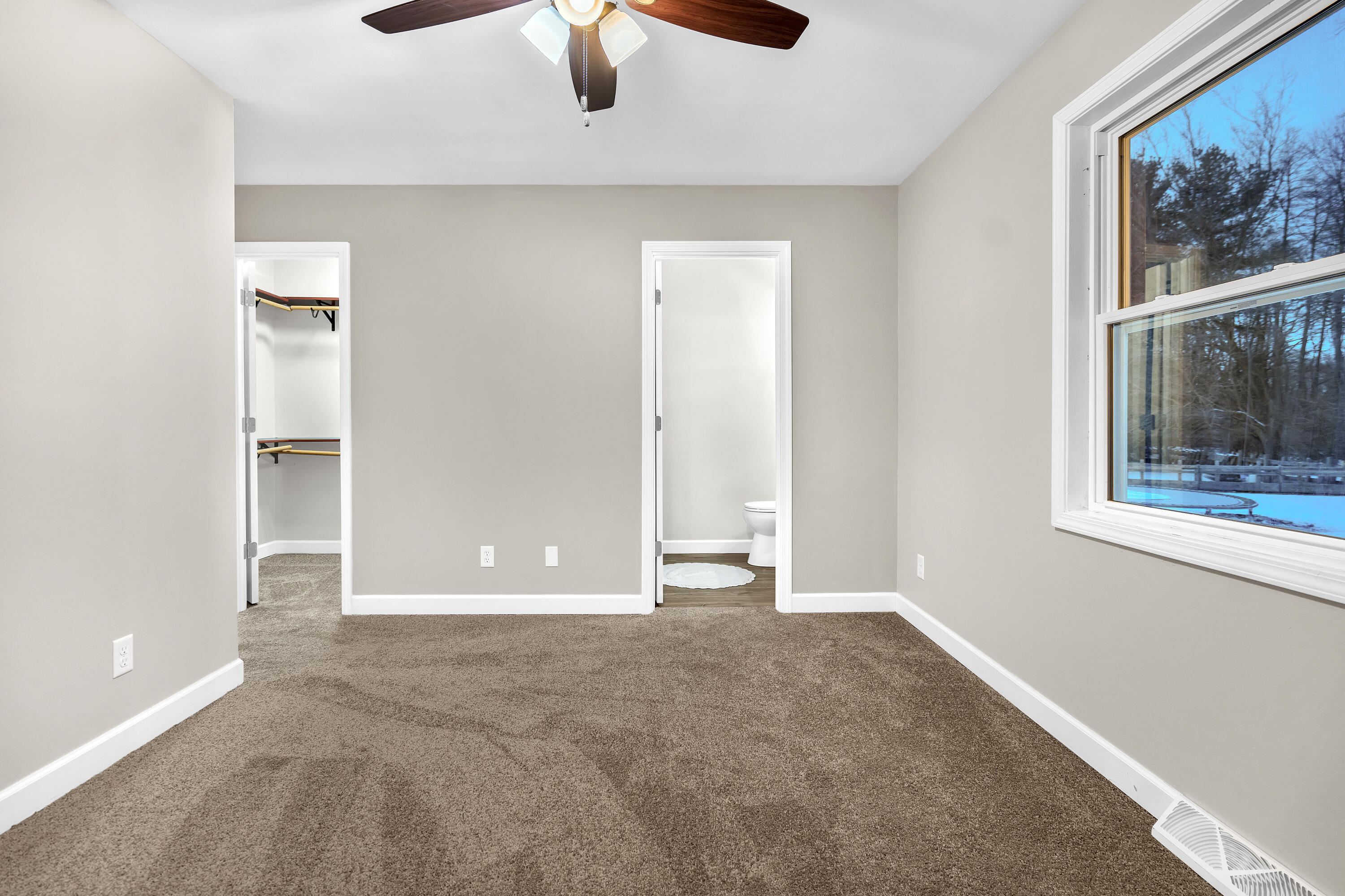 3902 North Explorer Lane Wheatfield, IN 46392 - Photo 18 of 34 an empty room with windows and chandelier fan