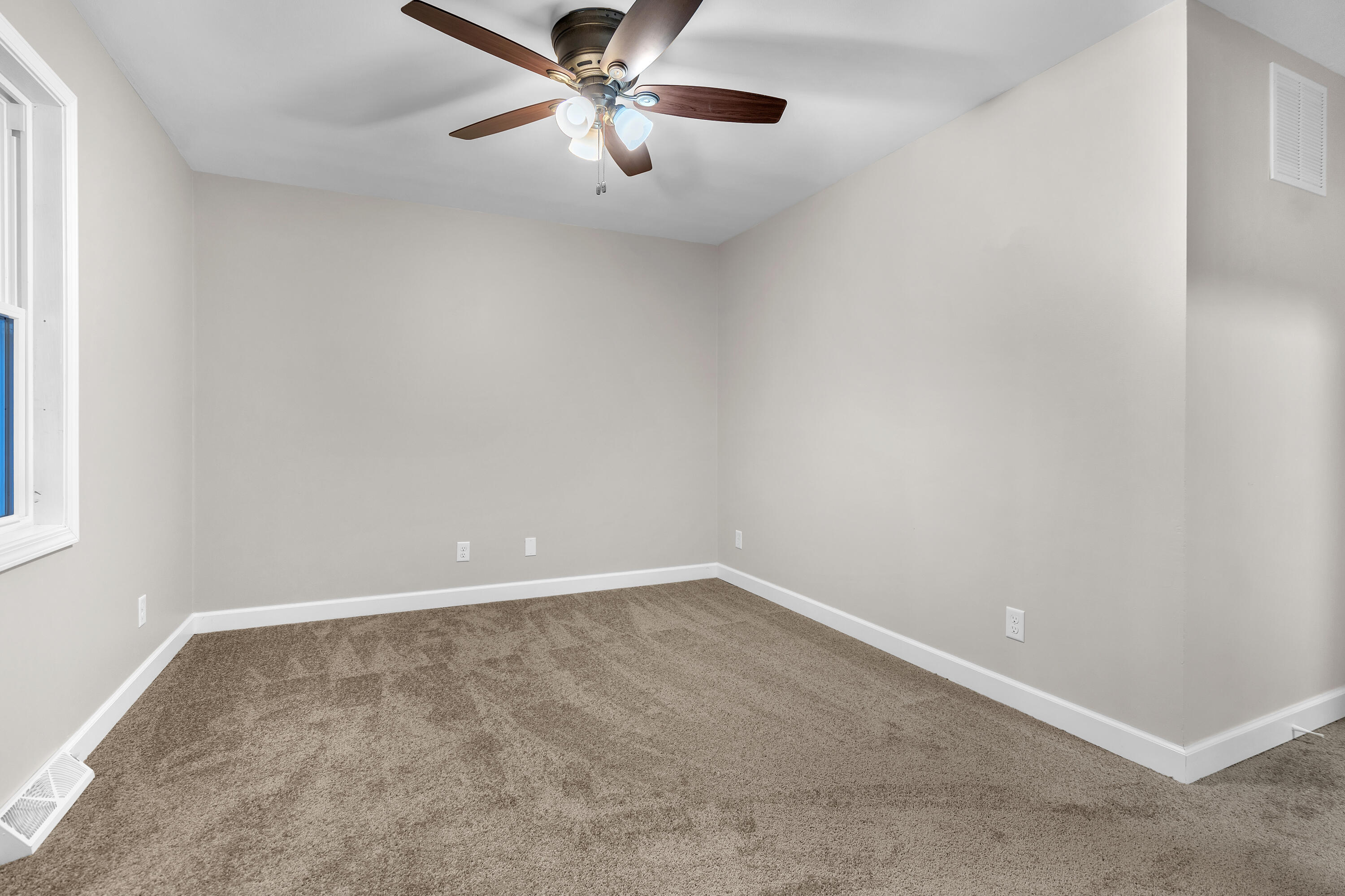 3902 North Explorer Lane Wheatfield, IN 46392 - Photo 19 of 34 an empty room with a window and a fan