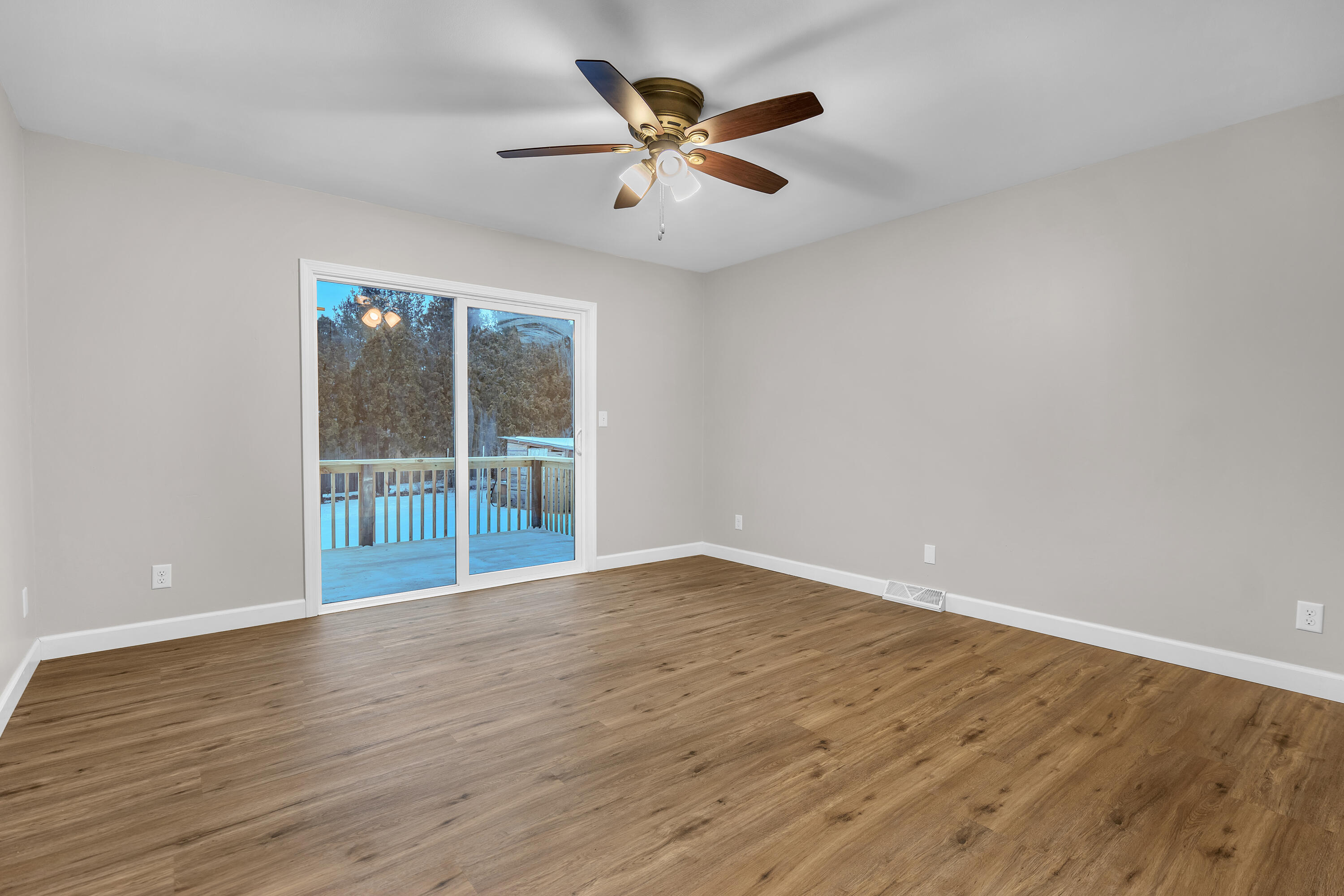 3902 North Explorer Lane Wheatfield, IN 46392 - Photo 10 of 34 a view of an empty room with wooden floor and a ceiling fan