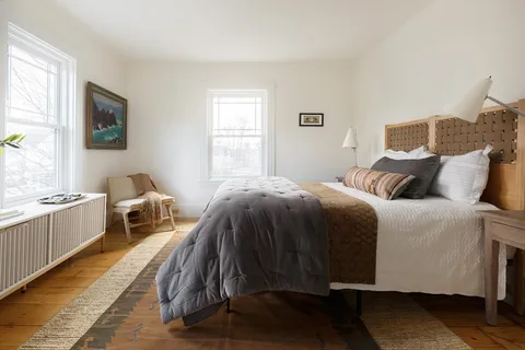 a bedroom with bed and a fireplace