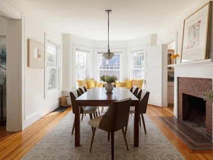 a view of a dining room with furniture window and wooden floor