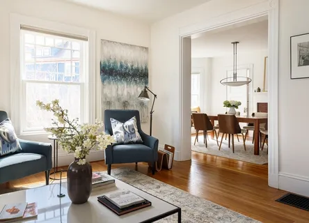 a kitchen with stainless steel appliances granite countertop a sink dishwasher stove and white cabinets with wooden floor