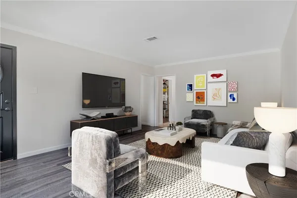 a living room with furniture a flat screen tv and a window