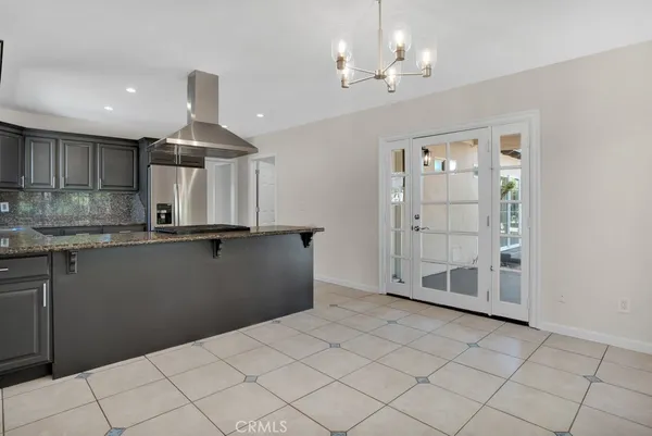 a kitchen with granite countertop a sink stove and cabinets