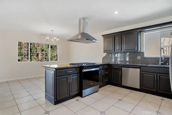 a kitchen with granite countertop a stove and a sink