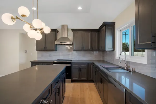 a kitchen with a sink a counter space cabinets and stainless steel appliances
