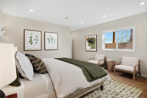 a bedroom with a bed and a couch