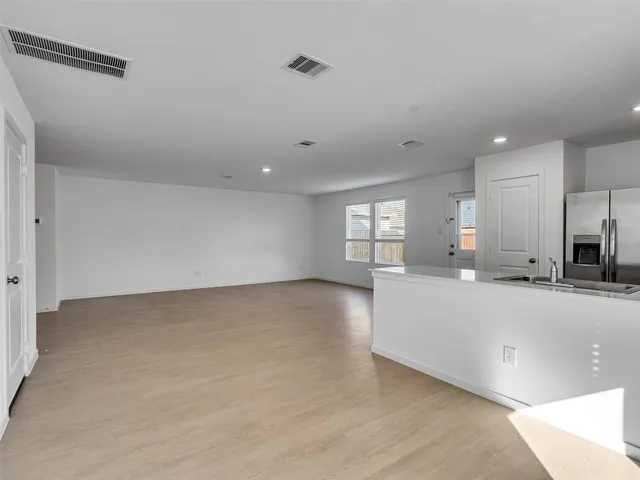 an empty room with windows and closet