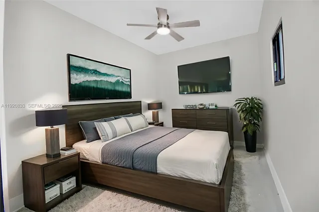 a bedroom with bed and a flat screen tv