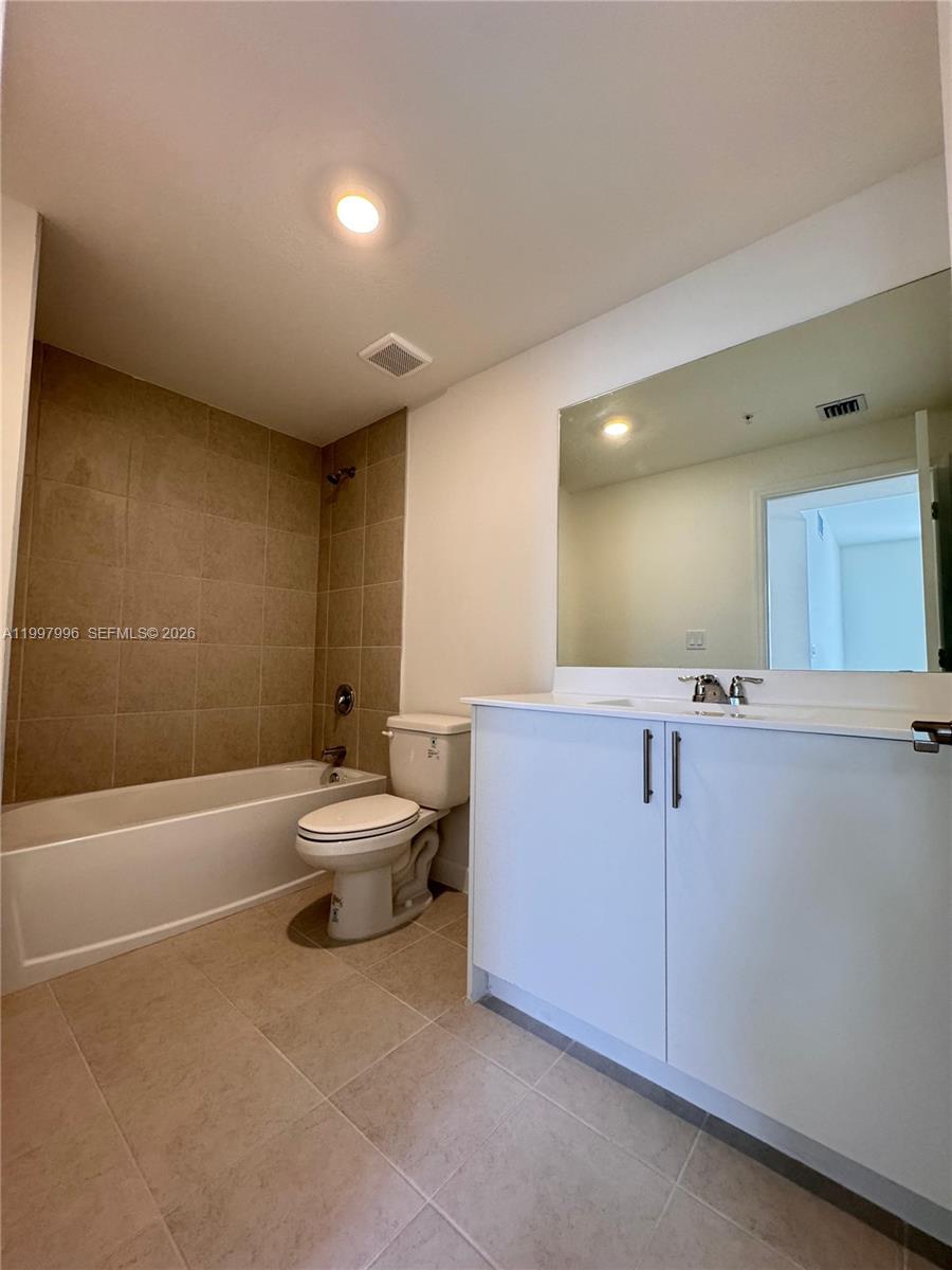 15615 Southwest 280th Street, Unit 10 Homestead, FL 33032 - Photo 12 of 23 a bathroom with a sink a toilet and a bathtub