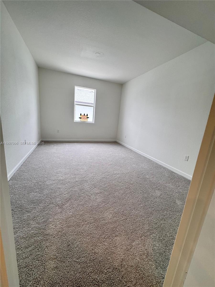 15615 Southwest 280th Street, Unit 10 Homestead, FL 33032 - Photo 16 of 23 a view of an empty room with a window
