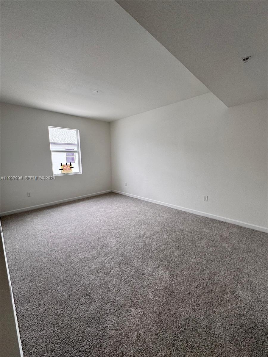 15615 Southwest 280th Street, Unit 10 Homestead, FL 33032 - Photo 19 of 23 an empty room with a window