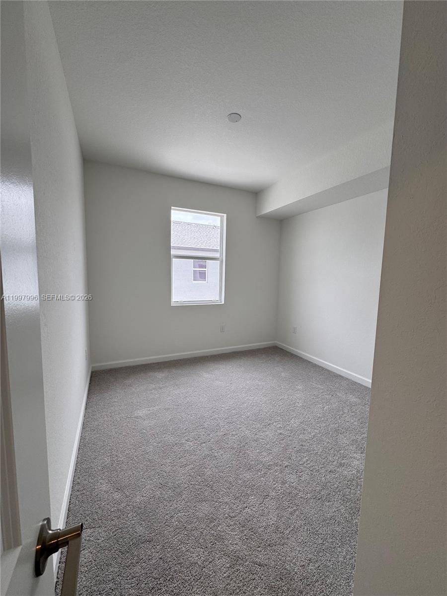 15615 Southwest 280th Street, Unit 10 Homestead, FL 33032 - Photo 21 of 23 an empty room with windows