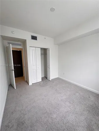 a view of an empty room and closet
