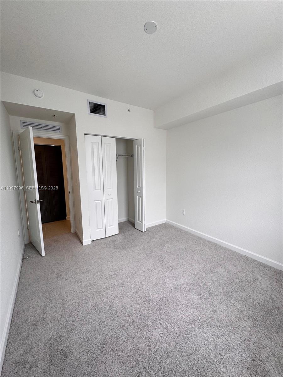 15615 Southwest 280th Street, Unit 10 Homestead, FL 33032 - Photo 22 of 23 a view of an empty room and closet