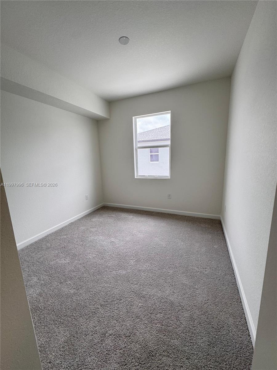 15615 Southwest 280th Street, Unit 10 Homestead, FL 33032 - Photo 23 of 23 an empty room with windows