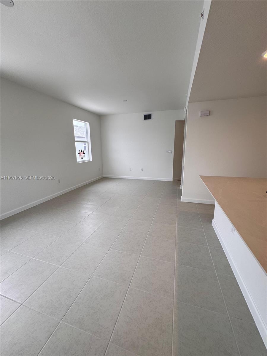 15615 Southwest 280th Street, Unit 10 Homestead, FL 33032 - Photo 7 of 23 an empty room with windows