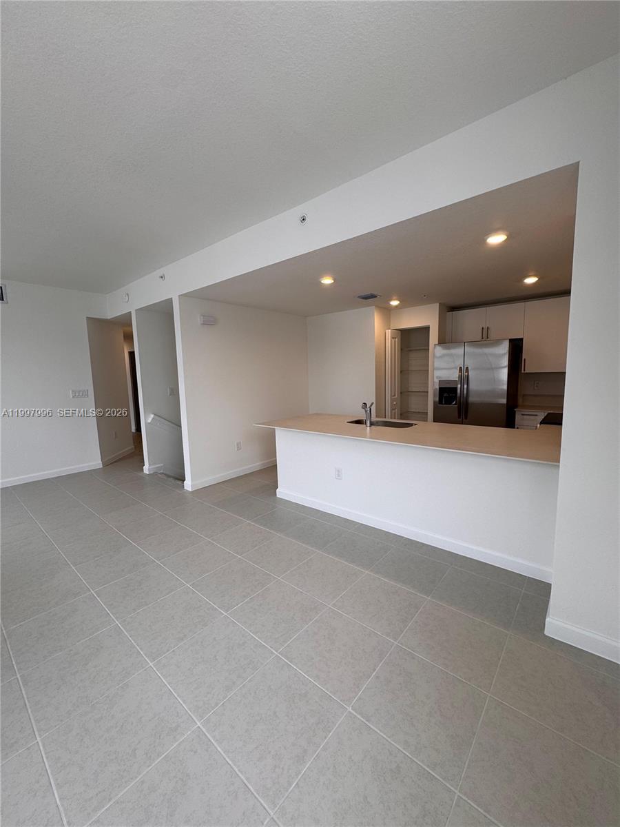 15615 Southwest 280th Street, Unit 10 Homestead, FL 33032 - Photo 8 of 23 a view of a kitchen with a sink and a stove top oven
