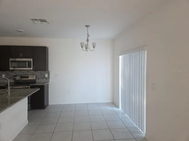 a kitchen with granite countertop a stove and a sink