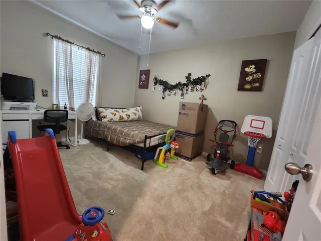 a bedroom with furniture and a flat screen tv