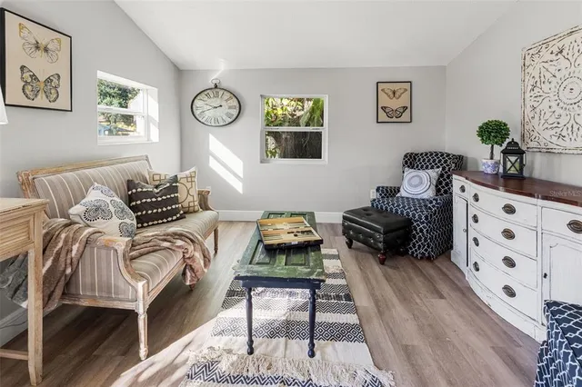 a bedroom with furniture and wooden floor