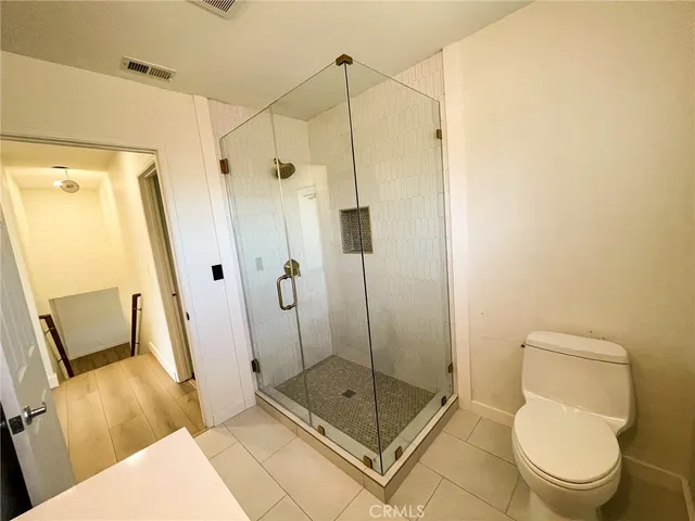 a bathroom with a shower toilet and sink