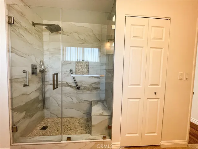 a bathroom with a glass shower door