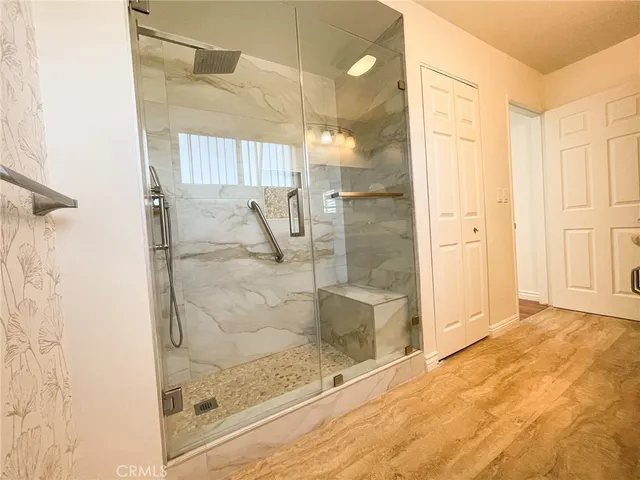 a bathroom with a glass shower door