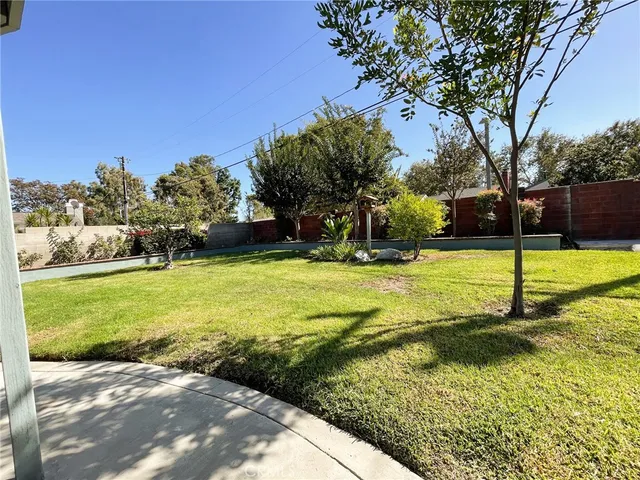 a view of yard with swimming pool and green space