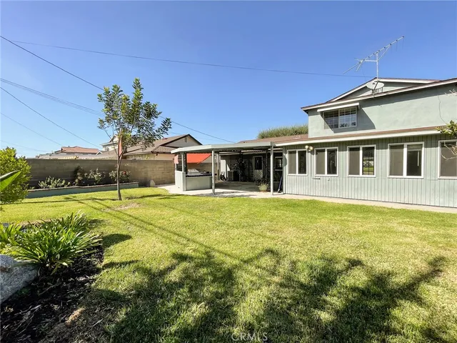 a swimming pool with outdoor seating and yard