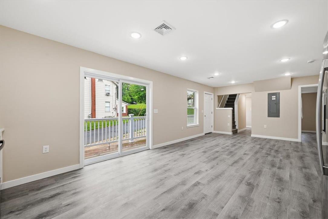 5641 North Coplay Road Whitehall, PA 18052 - Photo 13 of 68 Natural illumination fills this open-concept area featuring durable flooring and direct outdoor access.