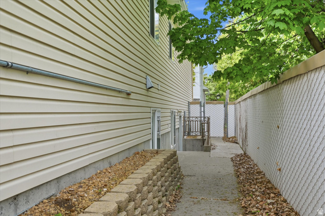 560 East 700 North Logan, UT 84321 - Photo 26 of 32 Beige horizontal siding exterior with a concrete foundation