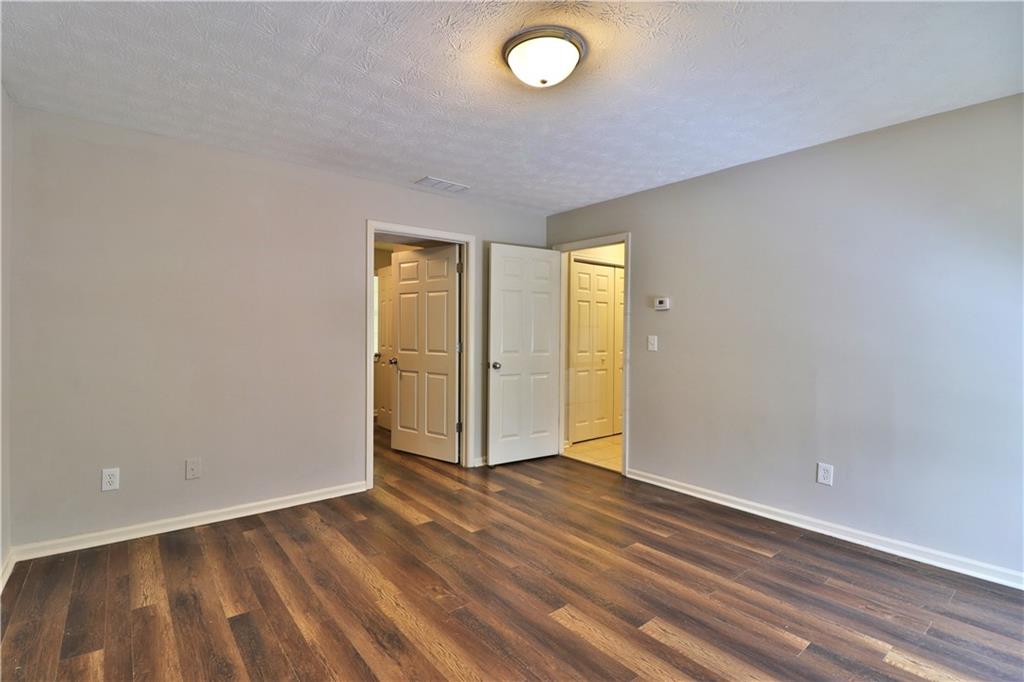 353 Fall View Court Winder, GA 30680 - Photo 51 of 61 an empty room with wooden floor and windows