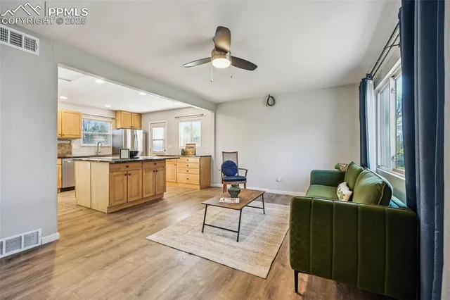a living room with furniture and kitchen view