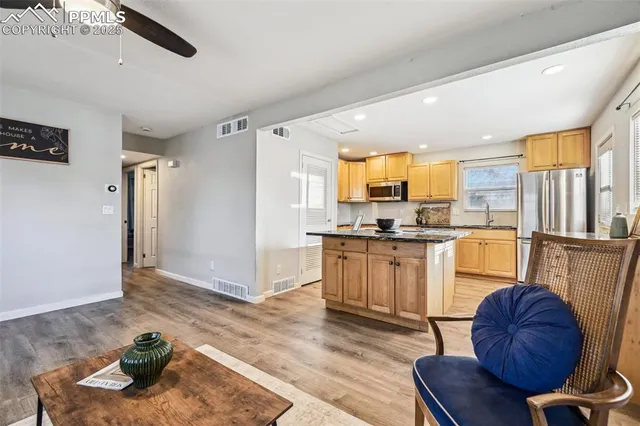 a kitchen with a refrigerator and a sink