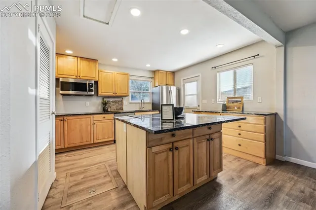 a kitchen with counter top space sink and stainless steel appliances