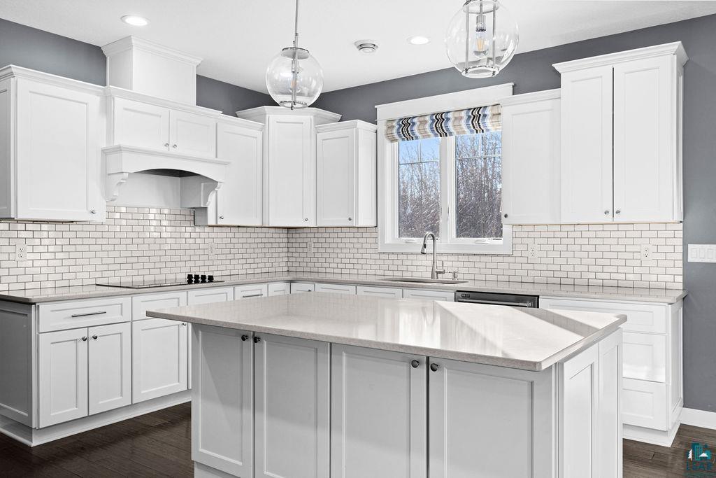 3879 Okerstrom Road Hermantown, MN 55811 - Photo 4 of 32 Kitchen featuring dark wood finished floors and white cabinets