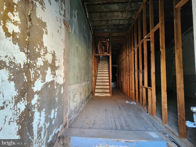 a view of a porch with wooden floor and stairs