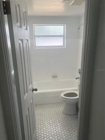 a bathroom with a toilet and a bathtub