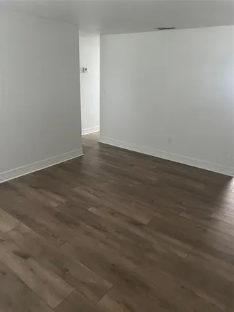 an empty room with wooden floor