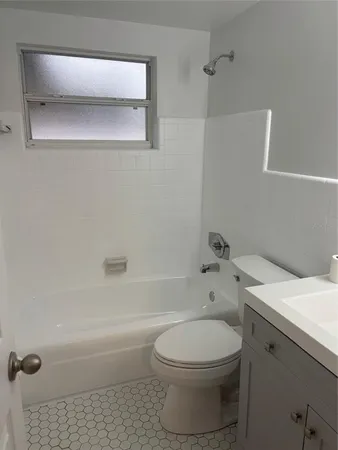 a bathroom with a toilet a sink and bathtub