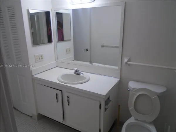 a bathroom with a sink toilet and mirror