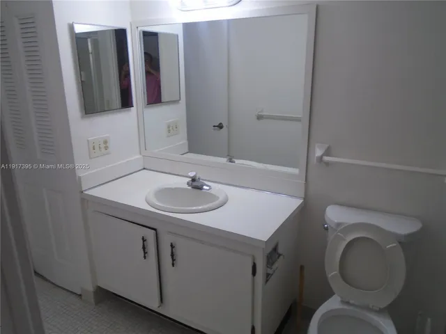 a bathroom with a sink toilet and mirror