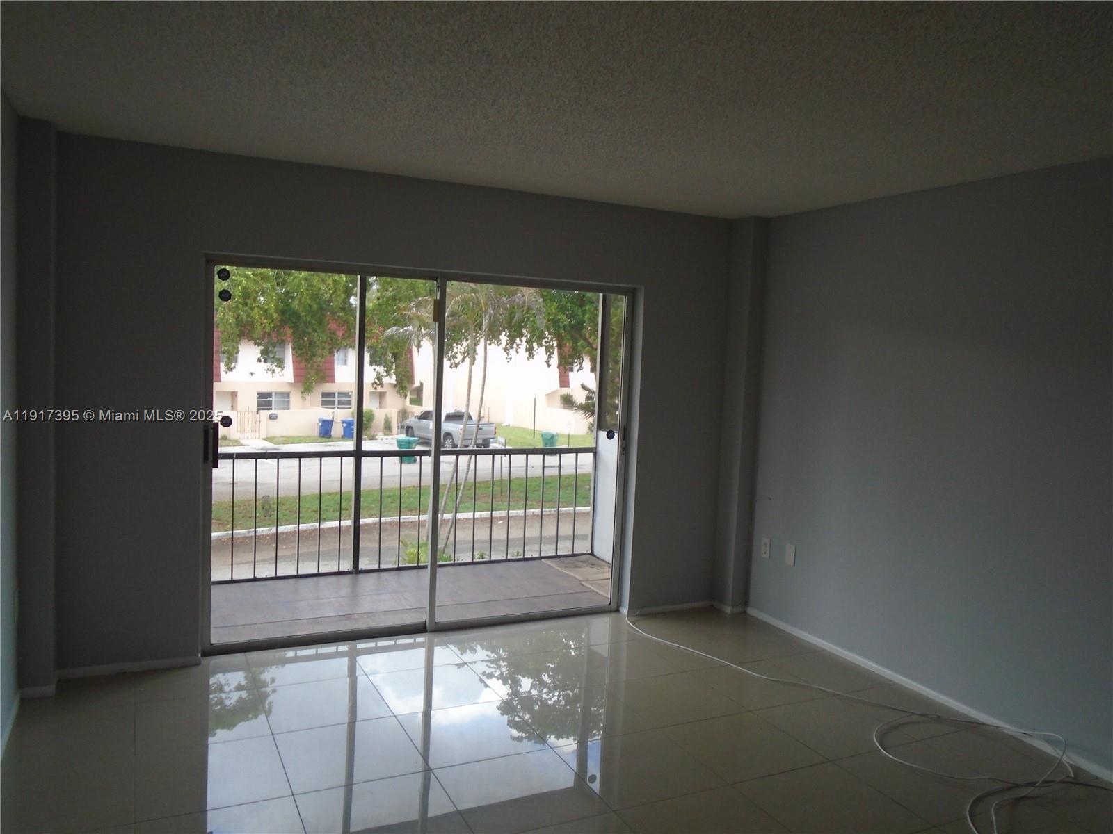 4176 Inverrary Drive, Unit 209 Lauderhill, FL 33319 - Photo 4 of 15 a view of an empty room with a balcony