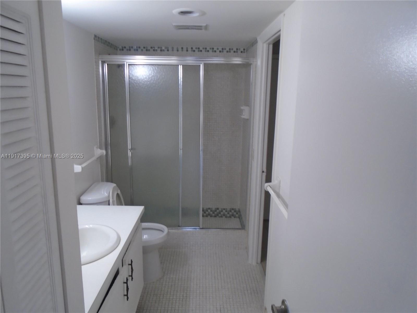 4176 Inverrary Drive, Unit 209 Lauderhill, FL 33319 - Photo 9 of 15 a bathroom with a sink a toilet and shower