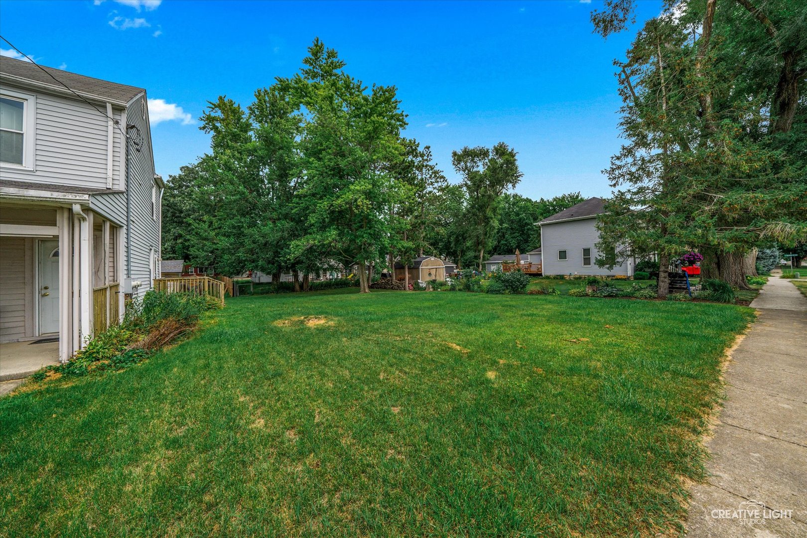 a view of house with backyard space and garden