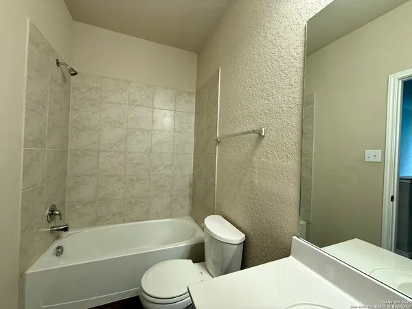 a bathroom with a toilet a sink and bathtub