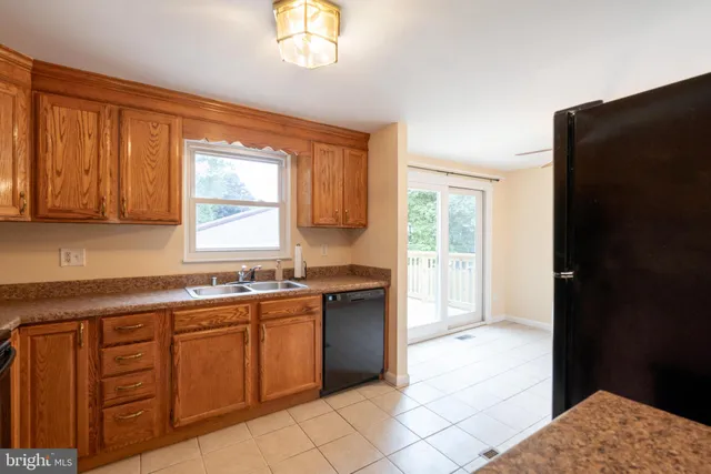 a kitchen with a sink window and cabinets